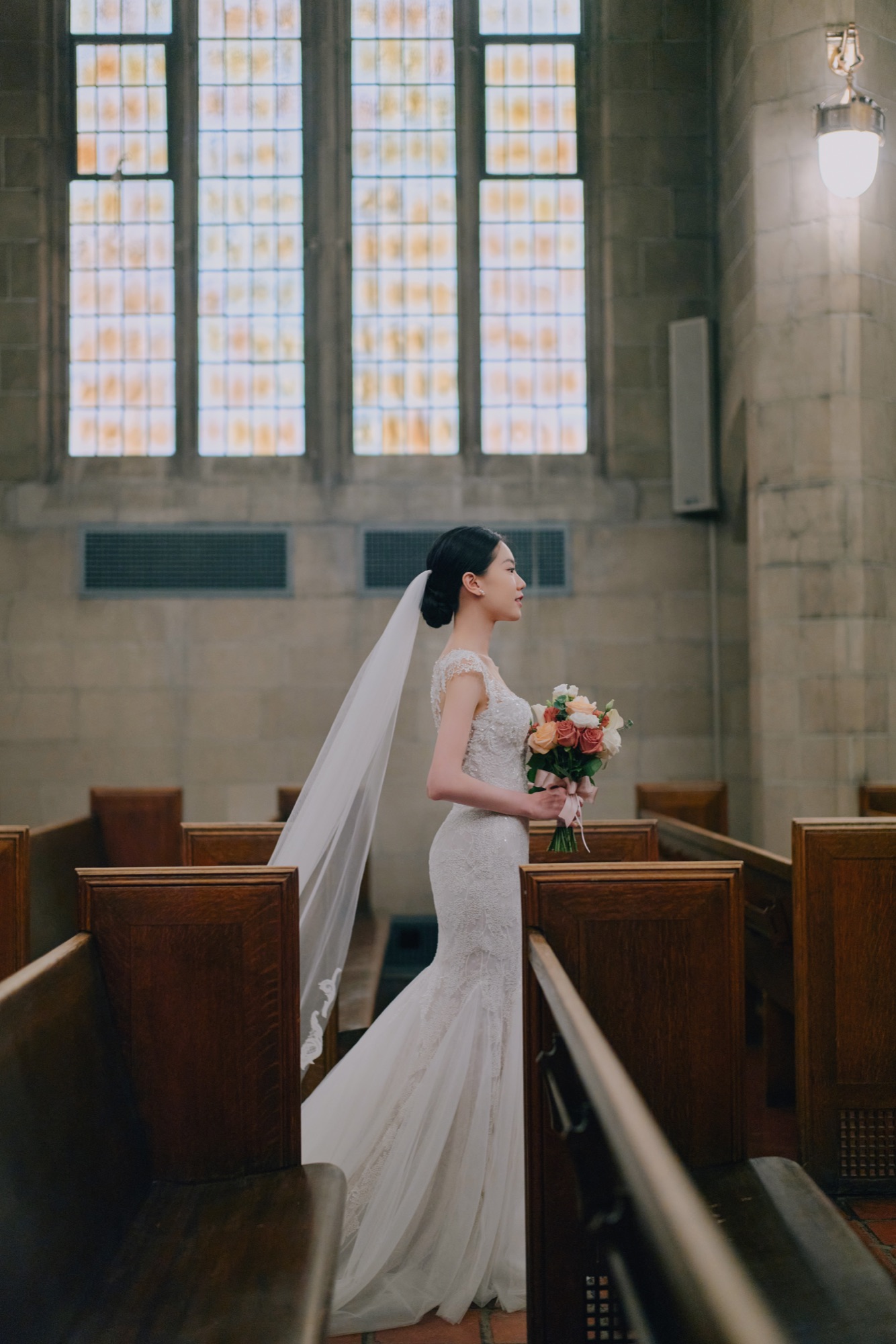 A bride standing in soft chapel light
