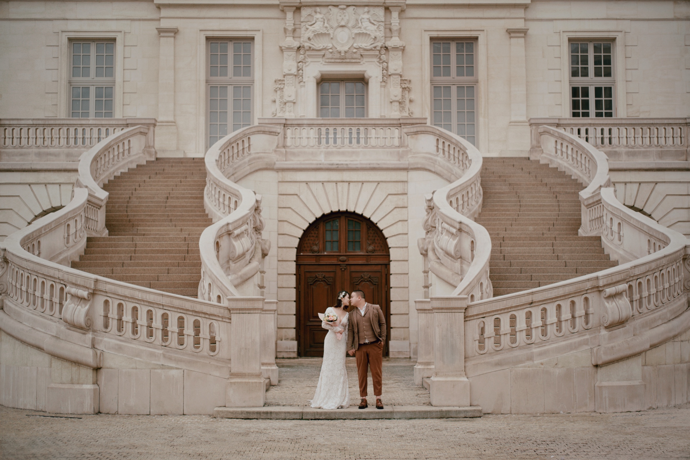 A wedding portrait framed by classical architecture